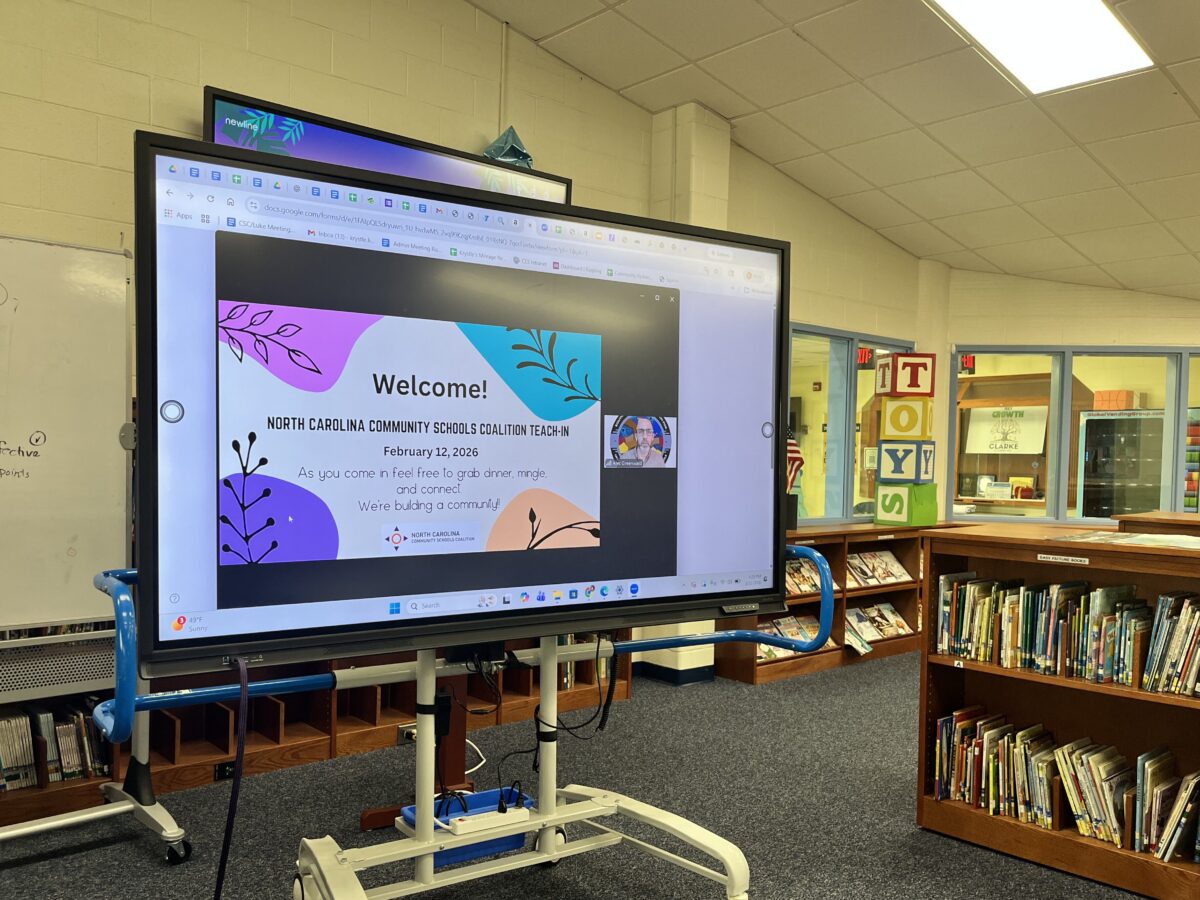 Photo of large screen showing teach-in zoom meeting at Clarke Elementary school